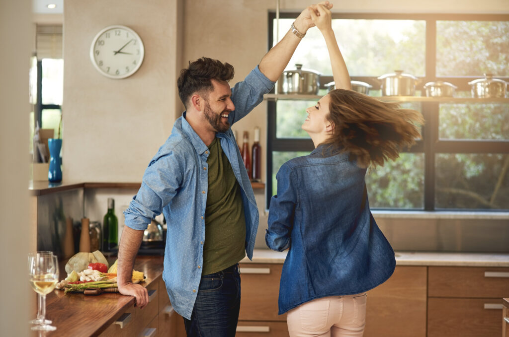 A couple celebrates purchasing their first home. 